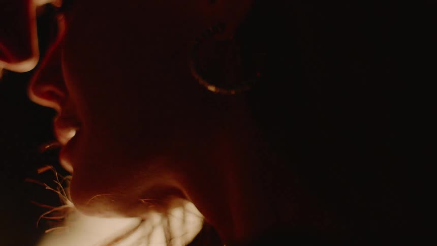 A fire burns around two lovers