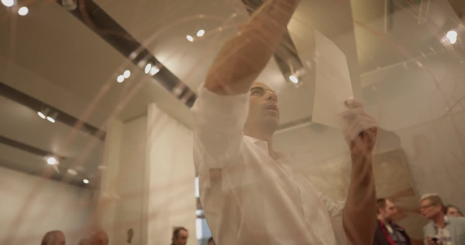 A man is looking at a piece of paper and drawing