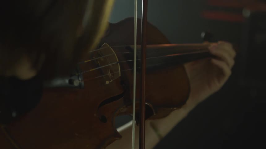 A woman playing a violin on stage