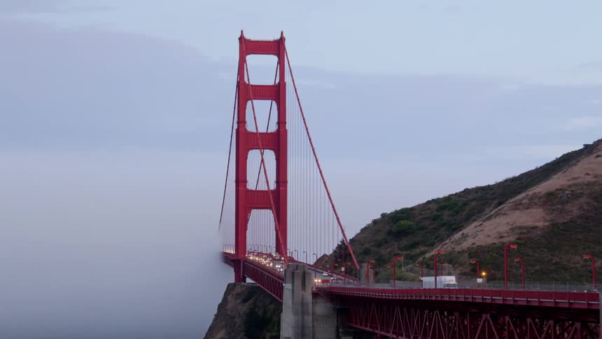 Clouds almost entirely covering a bridge