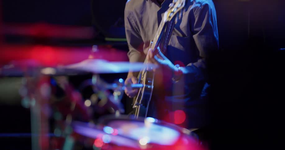 People play as a band on a stage