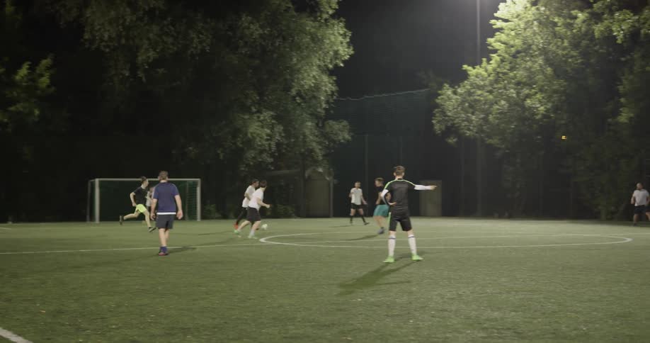 Two teams of boys play soccer