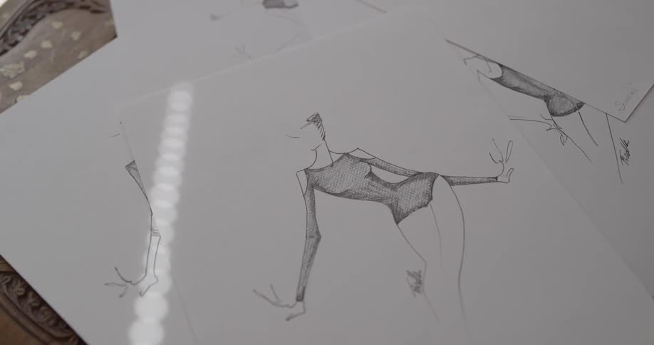 Pencil sketches of a faceless figure in a bodysuit