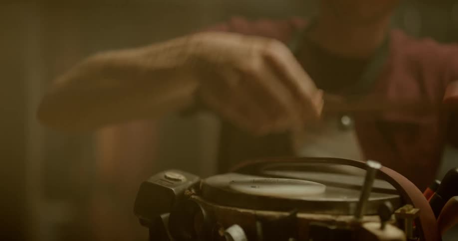 A man lays a strap down and uses a stamp on it