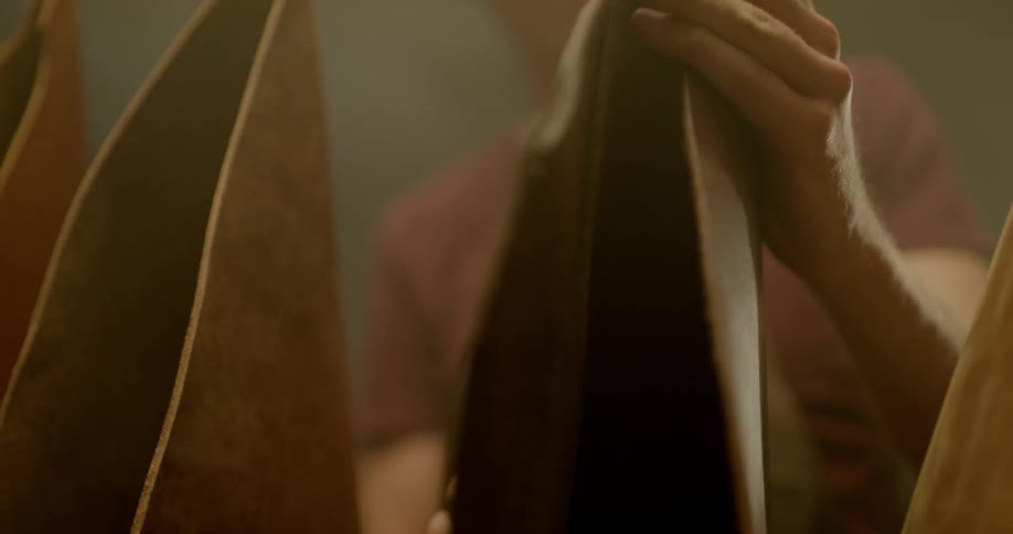 A man is touching leather in a room