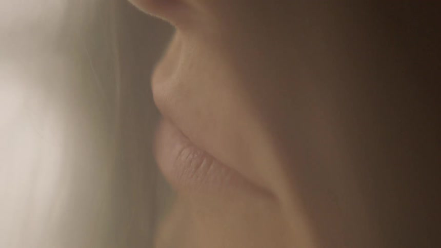 A woman with brown hair is standing still