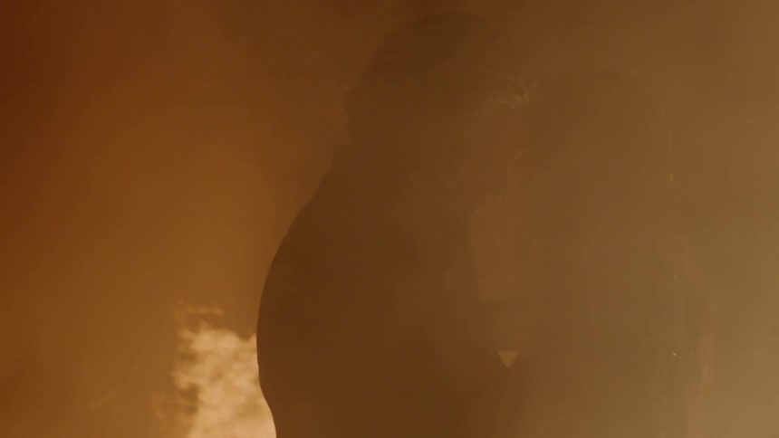 Man and woman dancing surrounded by fire and ash