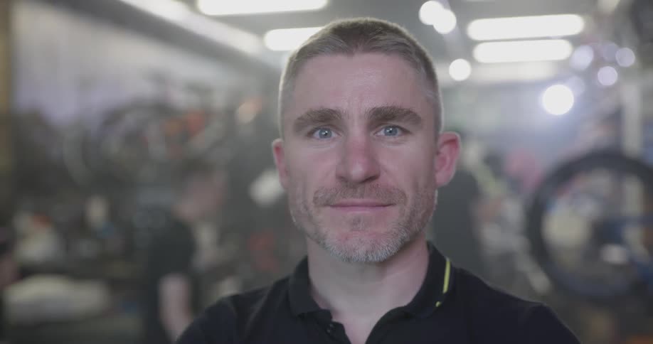 A bicycle shop employee smiles