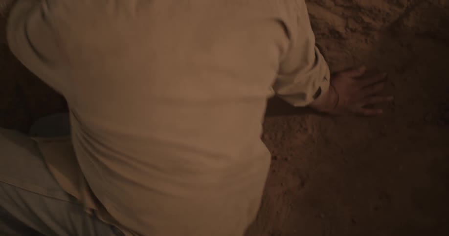 A man lies down in the dirt