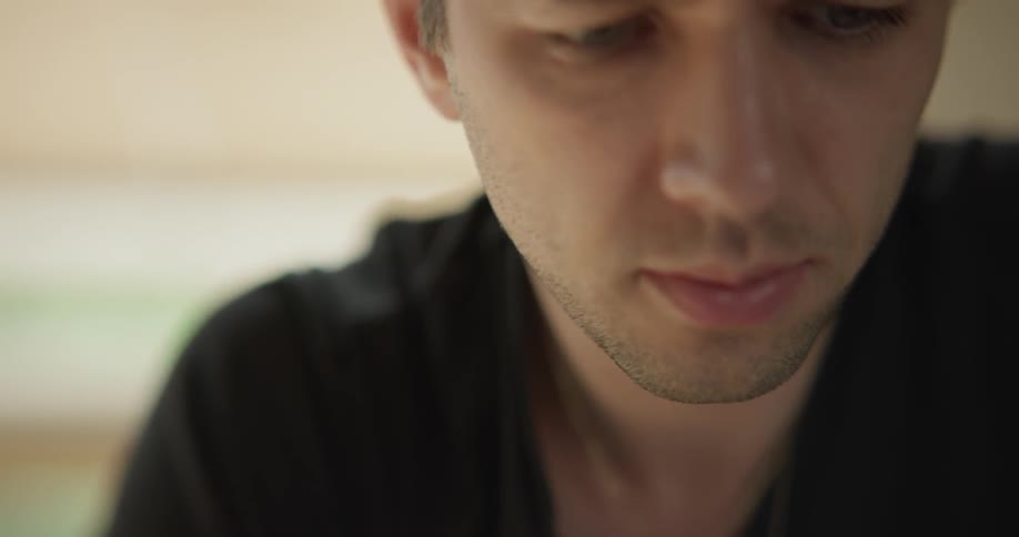 A man is indoors looking around