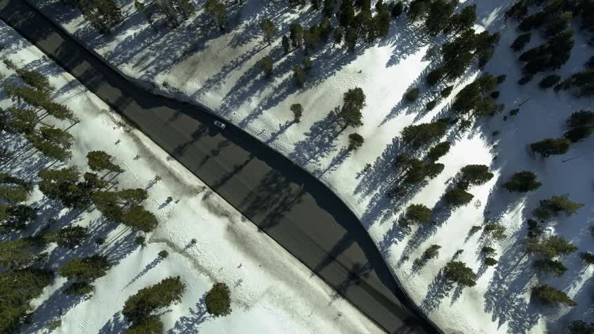 A road through a mountain area with snow
