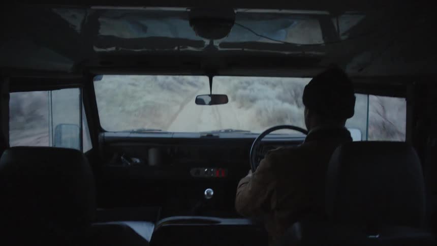 A man is driving on a road outside