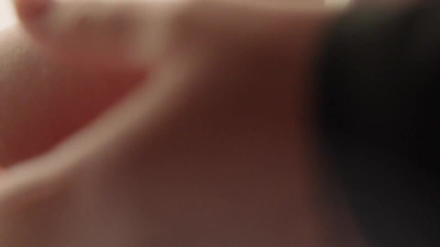 A person grabbing a baby's feet on a table