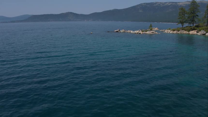 Water is rippling in lake in the mountains on sunny day