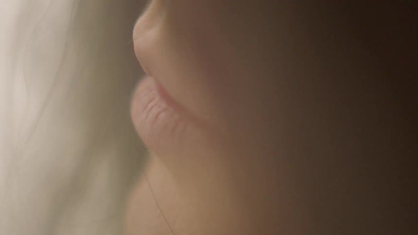 A woman staring into the distance on a sunny day