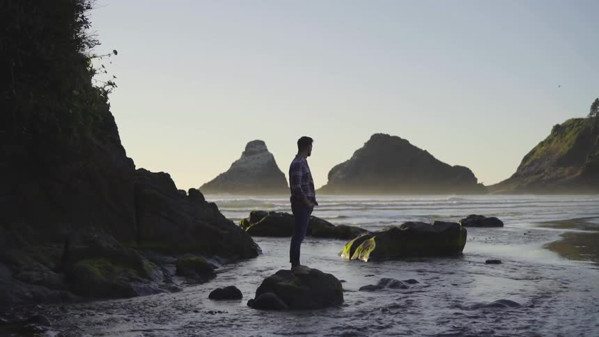 A man standing on a rock in a river