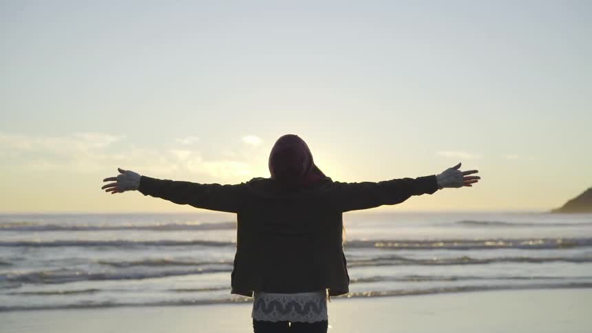 A woman stretching at the beach
