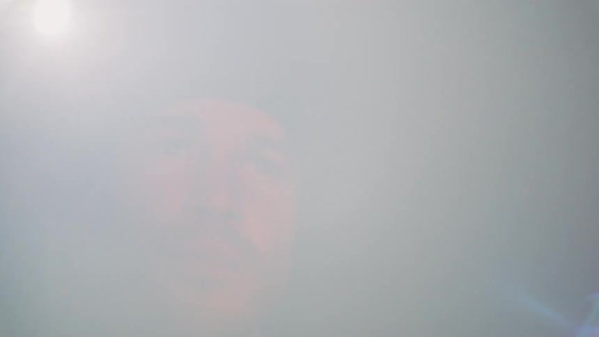 A man looking around at night with a flashlight