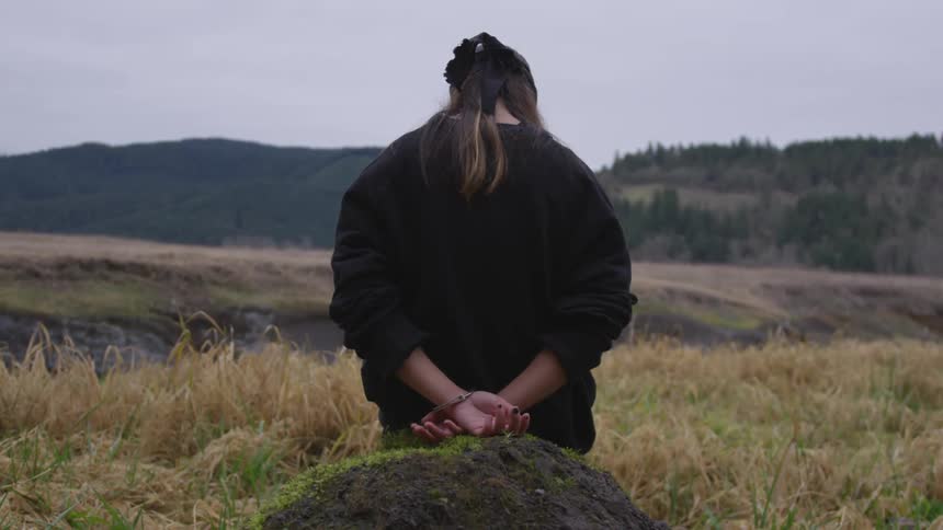 A woman sitting on a rock