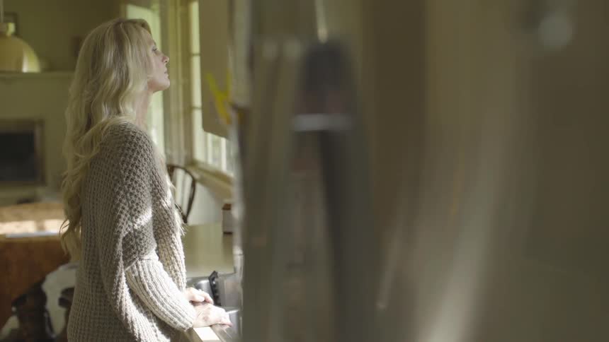 A woman is looking out a window