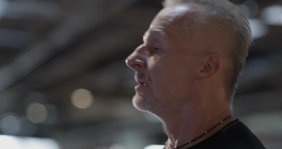 A man jogs on a treadmill in a gym