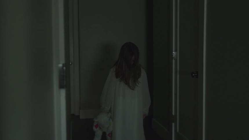 A person staring down a hallway