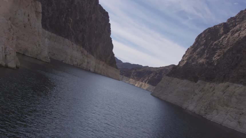 A gorge has steep cliffs with a river running between them