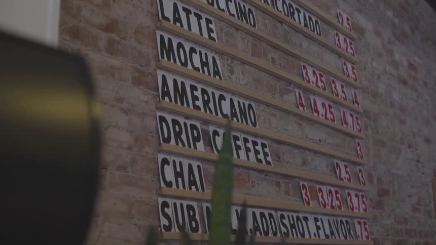 Coffee prices are displayed on the wall