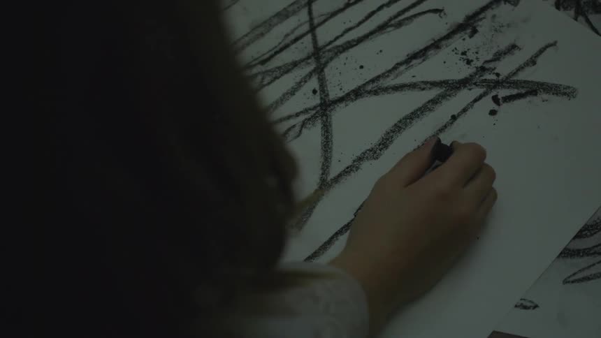 A child is drawing on paper