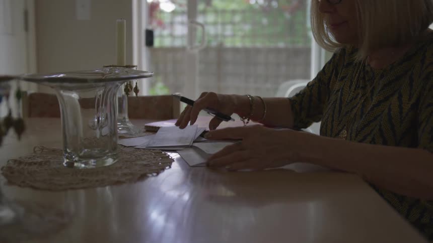 A woman reading papers on a table