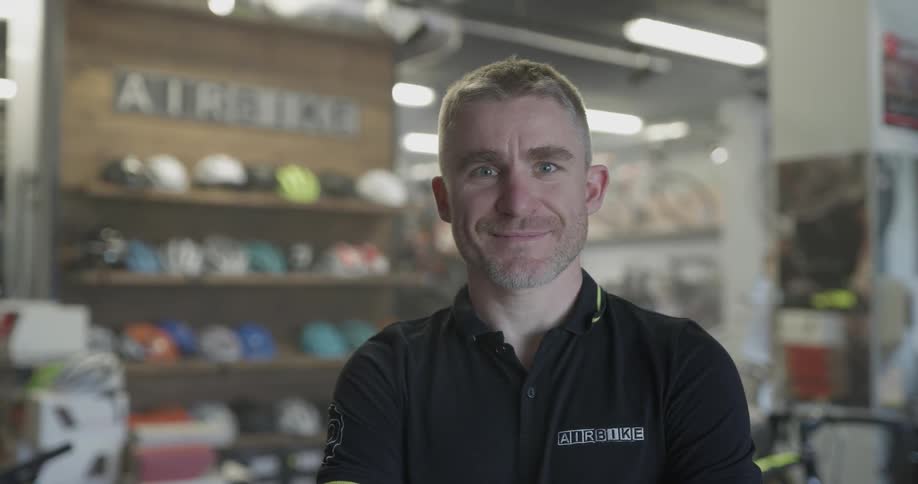 Man smiles at camera in shop