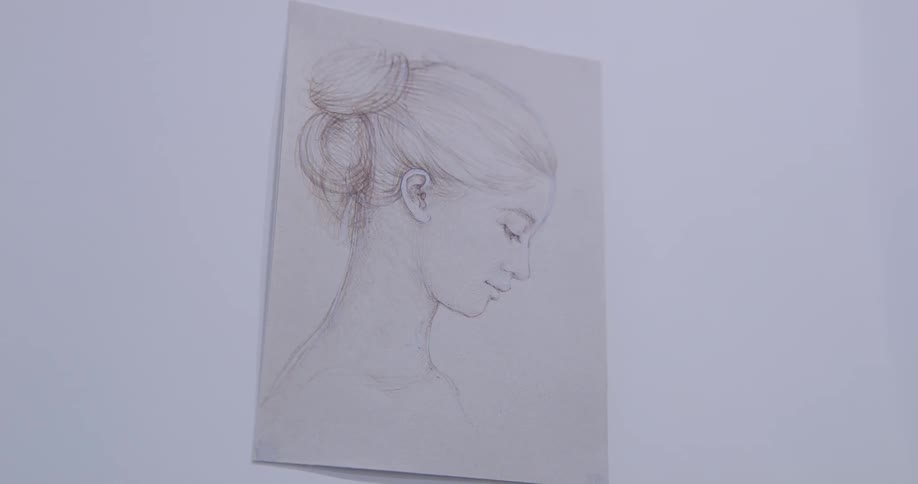 A painting of a female hangs on the wall