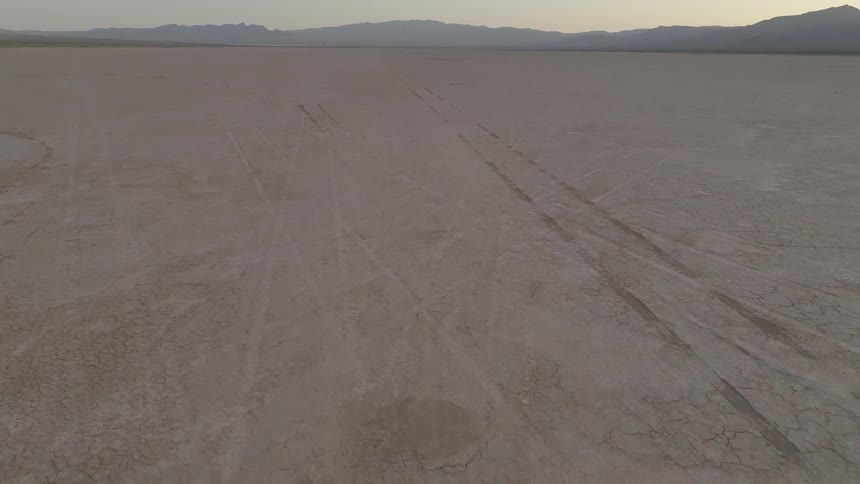 A jeep is racing across the desert