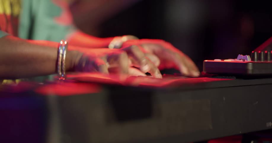 Man dances as he plays keyboard