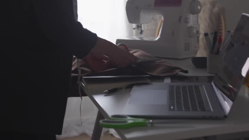 A woman uses scissors to cut