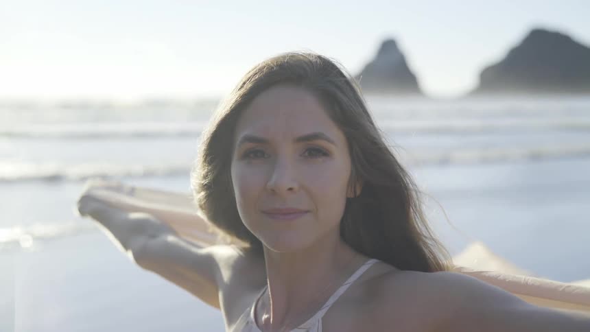 A woman is outside by the beach