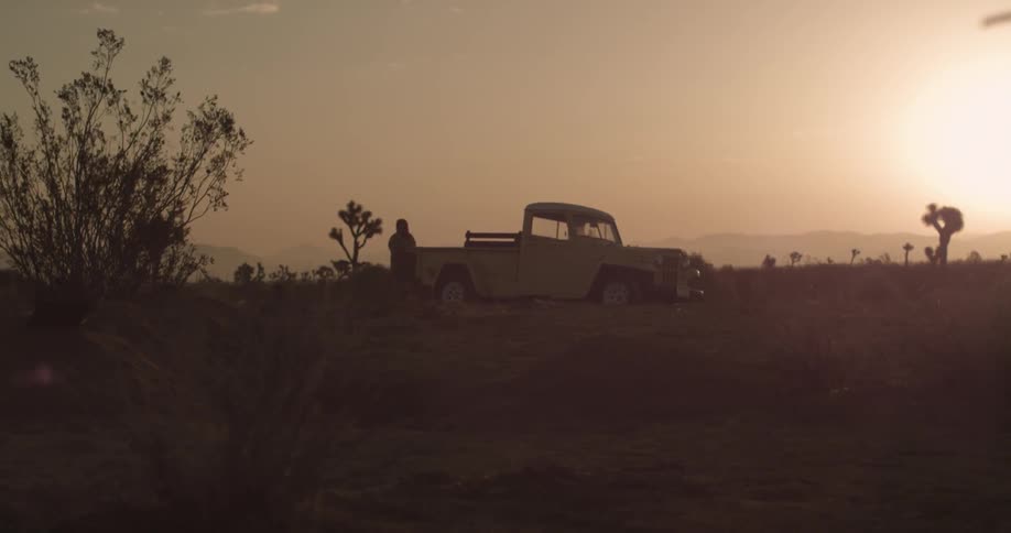 A person removing something from the bed of a pickup