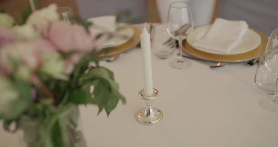 A candlestick is placed on a decorated dining table