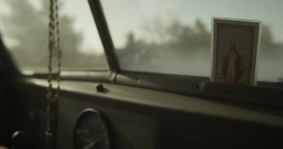 A car is driving down the road