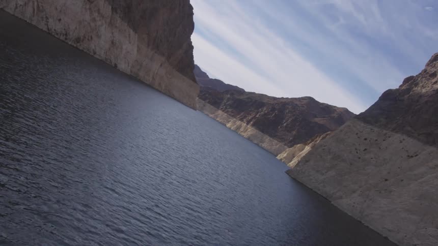 A river is flowing through a canyon on a cloudy day