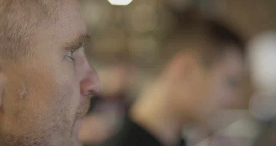 Man looks forward with others in background