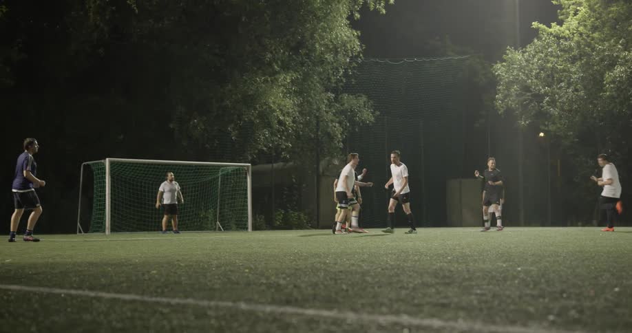 A group of men playing soccer on a field