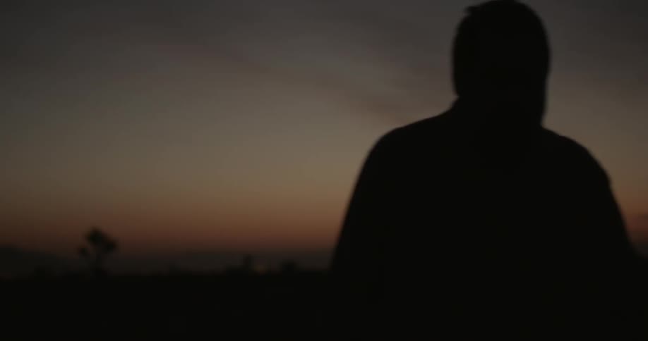 A person walking in the dusk