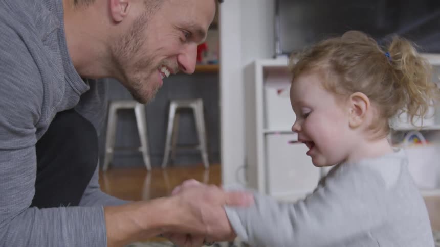 A father playing with his daughter