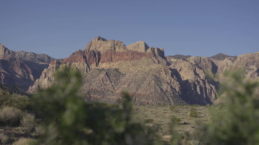 Past the field is a large mountain range