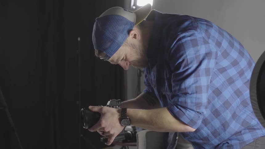 Man looks down through a camera