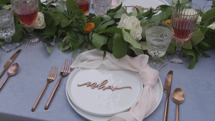 Place setting at table with floral centerpiece