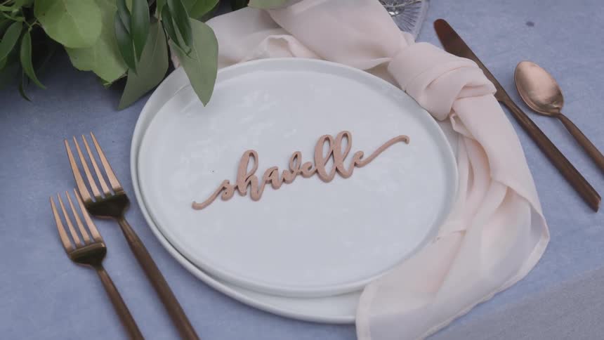 A table setting that is set outdoors on a sunny day