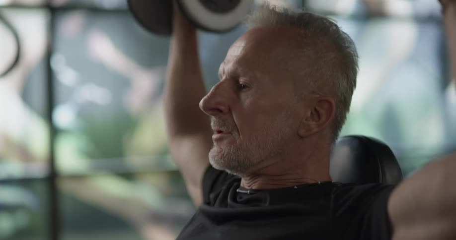 A man is lifting weights over his head