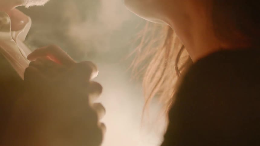 Couple Kissing By Fire In Desert
